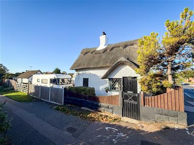 SIDE VIEW OF COTTAGE